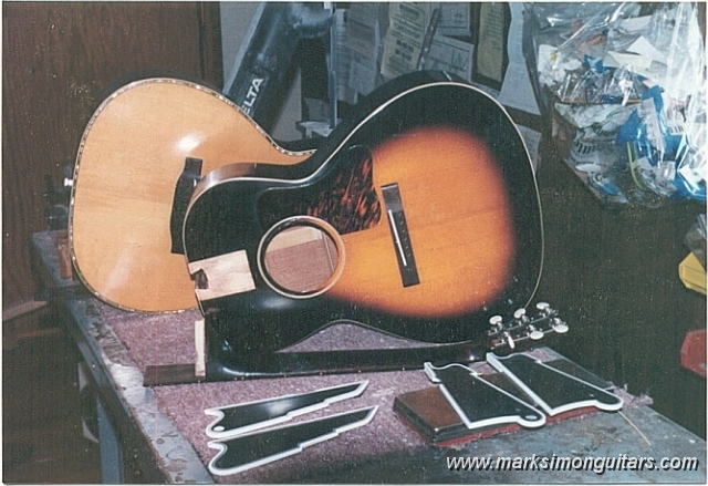 bigl00andpickguards.jpg - Sunburst L-00 with neck removed, shimmed and heel cut to proper angle waiting reinsertion to the body. Behind it is a Martin 00-40 with its neck already removed.